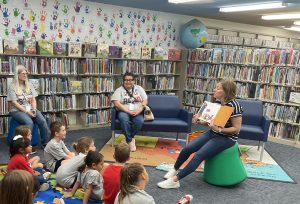 Librarian reads to group of children at the library.