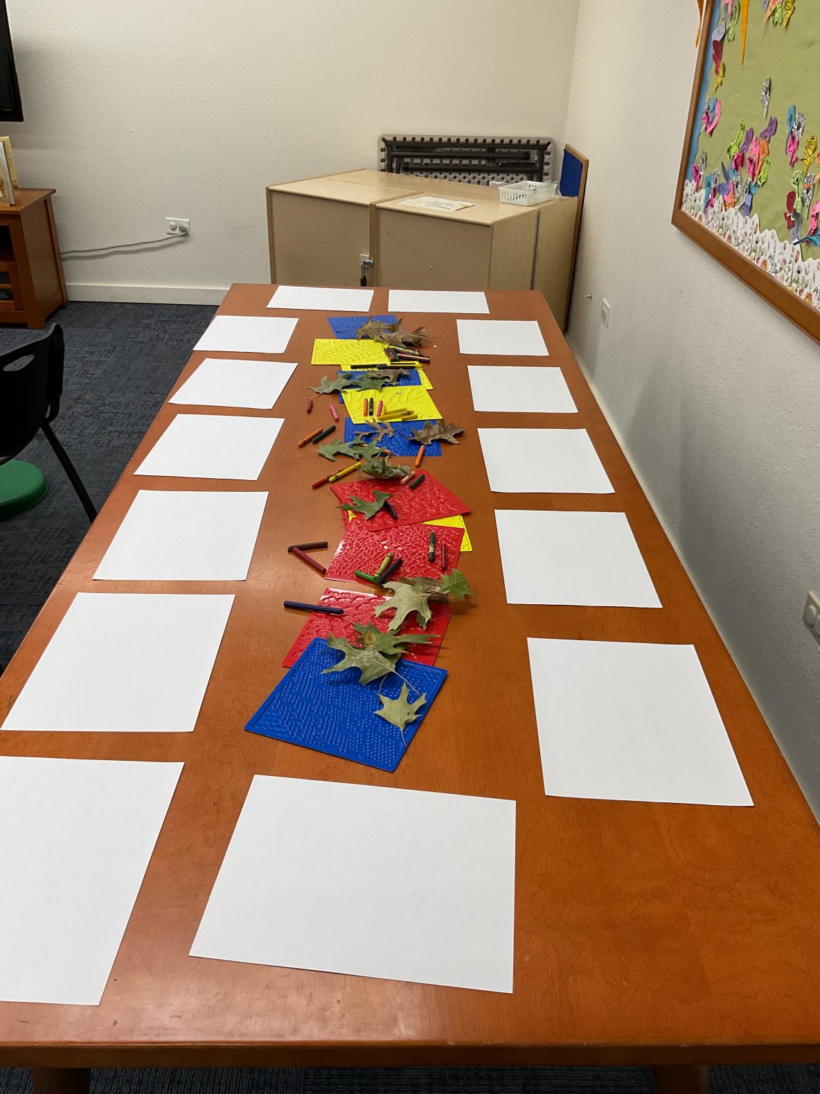 blank paper and leaves ready for children to make leaf rubbings!